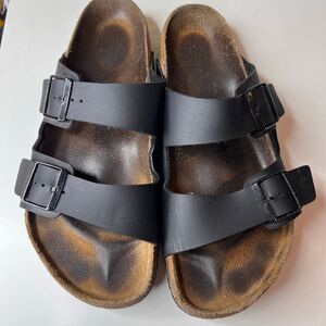 These sandals are the Birkenstock Arizona model in black 12- 12.5